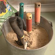 A bucket filled with sand and mineral oil keep tools clean and rust free.