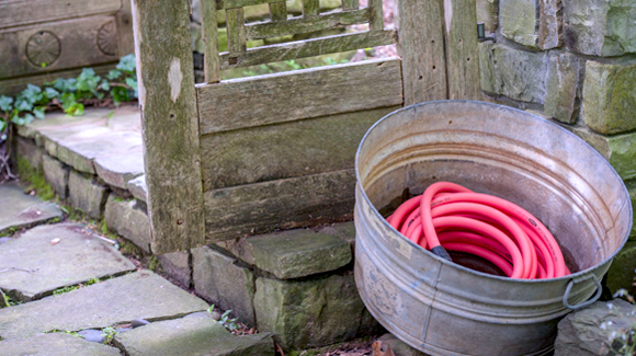 Use a galvanized tub to store garden hoses. P. Allen Smith Water Colors Collection in Coral Candy